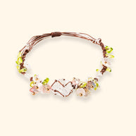 Daisy Chain — main view of clear quartz and braided cord bracelet with an open-heart centerpiece