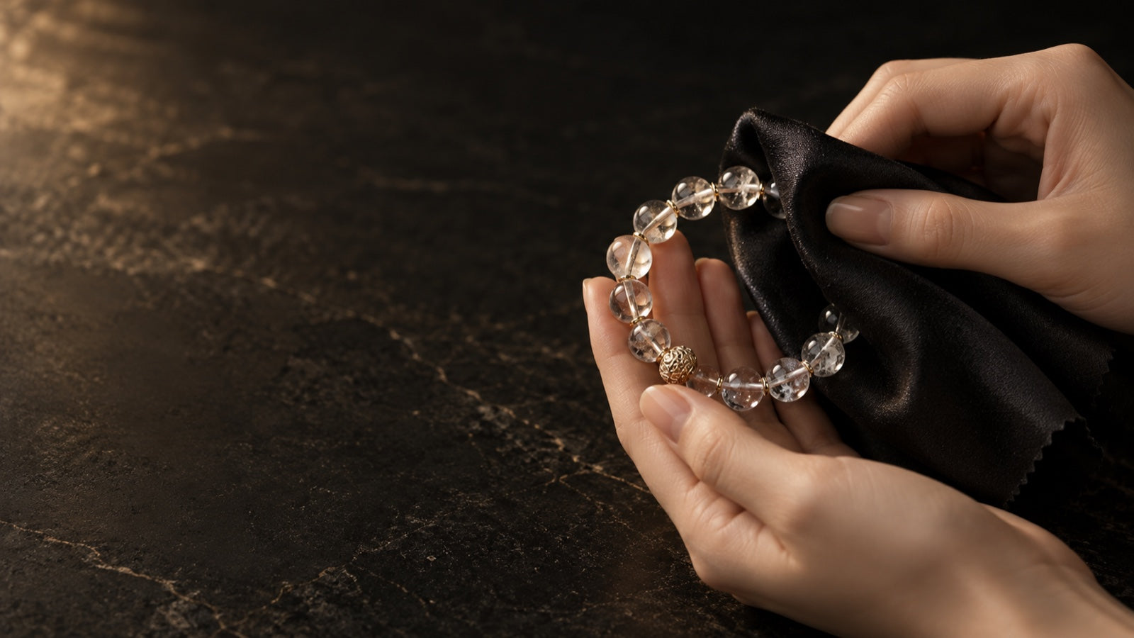 Crystal bracelet being gently cleaned with a soft black cloth